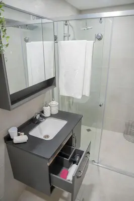 a bathroom with a sink and a shower at Стилен и уютен апартамент в центъра Варна in Varna City