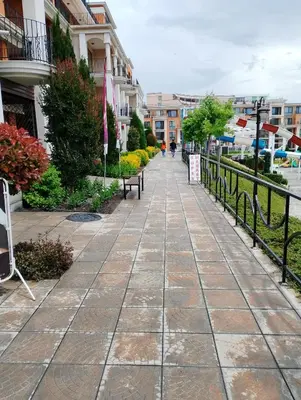 a walkway in a city with buildings at Private Apartment in PREMIER FORT Beach Aparthotel in Sveti Vlas