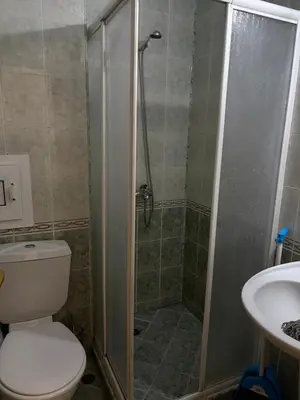 a bathroom with a shower and a toilet and a sink at Апартамент Бриджит Слънчев бряг in Sunny Beach