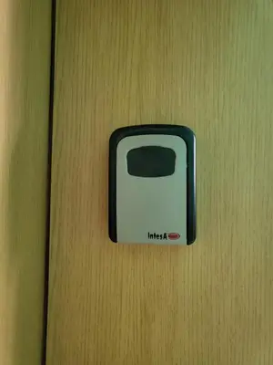a black and white switch on a wooden wall at Апартамент Бриджит Слънчев бряг in Sunny Beach