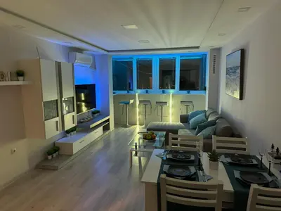 a living room with a couch and a table at Апартамент Панорама Славейков in Burgas City