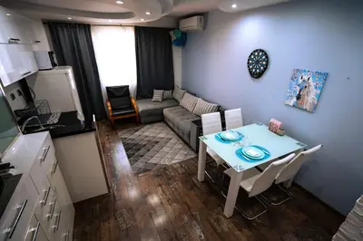 a small living room with a table and a couch at Seaside Apartament in Burgas City
