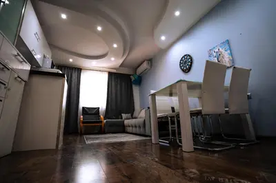 a living room with a table and a couch at Seaside Apartament in Burgas City