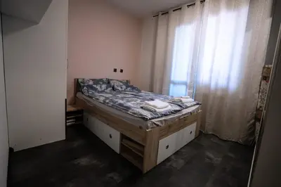 a bed in a room with a window at Seaside Apartament in Burgas City