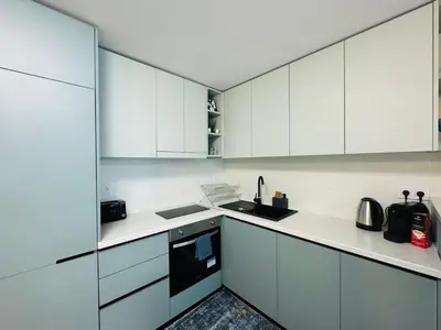 a white kitchen with white cabinets and appliances at PARADISO 'В' - 107 Panoramic Sea View Large STUDIO Nessebar in Nesebar