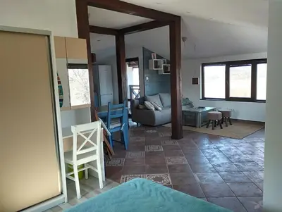 a living room with a couch and a table at Горе на вилата in Shkorpilovtsi