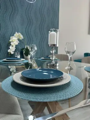 a dining room table with blue plates and glasses at Elizi summer house in Varna South Bay Beach in Varna City