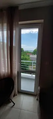 a room with a large window with a view of the water at Семеен Хотел ''Кораб Ренеса'' in Ravda
