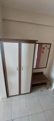 two white cabinets in a room with a tile floor at Семеен Хотел ''Кораб Ренеса'' in Ravda