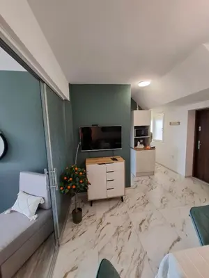 a living room with a large marble floor at LaRenta Стилни апартаменти с 2 спални и гледка море в Свети Влас in Sveti Vlas