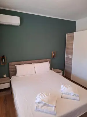 a bedroom with a bed with two towels on it at LaRenta Стилни апартаменти с 2 спални и гледка море в Свети Влас in Sveti Vlas