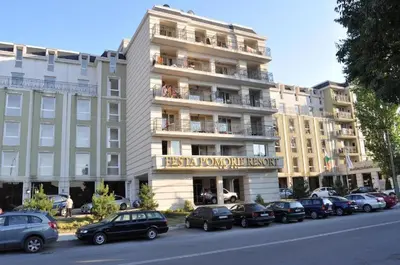 a large building with cars parked in front of it at Частно студио в комплекс Поморие Ризорт in Pomorie