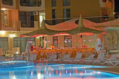 a swimming pool with chairs and a bar in a hotel at Grenada - Apartments by the beach in Sunny Beach