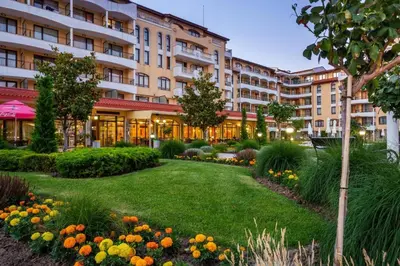 a garden in front of a large building at Royal Sun - Premium Apartments in Sunny Beach