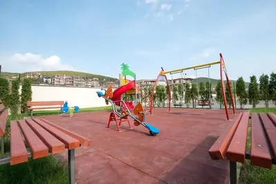 a park with a playground and a swing set at Macon Residence - Premium Apartments in Sveti Vlas