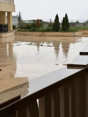 a flooded parking lot in front of a building at Gold Coast SP apartments in Burgas City