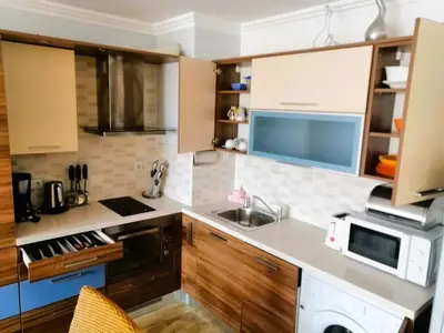 a kitchen with a sink and a microwave at MONASTERY Seafront Apartments in Sveti Vlas