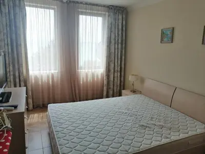 a bedroom with a large white bed with a window at MONASTERY Seafront Apartments in Sveti Vlas