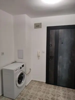 a laundry room with a washing machine and a door at rozi in Burgas City