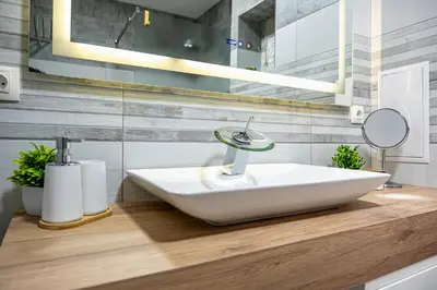 a bathroom with a sink on a wooden counter at Boutique 1 bedroom apartment with Private Parking and Port View in Varna City