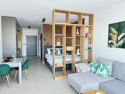 a living room with a bed and a room with a couch at Sea la Vie in Sozopol