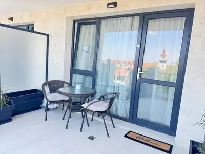 a patio with a table and chairs on a balcony at Wave & Sea in Sozopol
