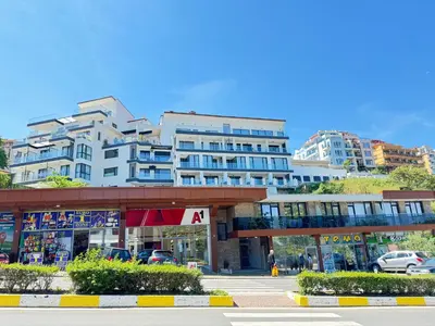 a large building with a parking lot in front of it at Wave & Sea in Sozopol