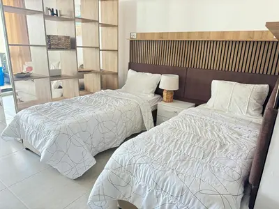 a bedroom with two beds and a lamp at Wave & Sea in Sozopol