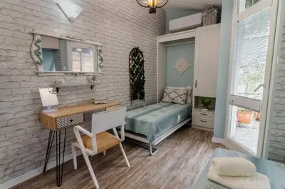 a small room with a desk and a bed at Bella in Nesebar