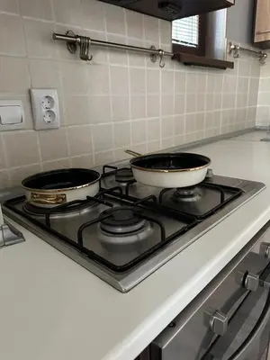 two pots on a stove top in a kitchen at Kambani 1 Apartment in Sveti Vlas