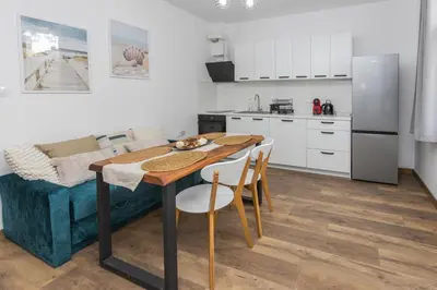 a kitchen with a table and chairs in a room at The Central House 1 in Burgas City