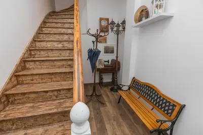 a staircase in a room with a bench and an umbrella at The Central House 1 in Burgas City