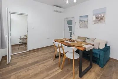 a dining room with a table and a couch at The Central House 1 in Burgas City