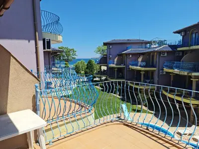 a balcony with blue fences on a building at Апартаменти за гости ГАРДЪН БИЙЧ in Chernomorets