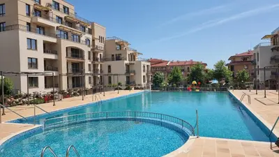 a large swimming pool in front of some buildings at Sorrento Sole Mare V&D Luxury Style Apartment in Sveti Vlas