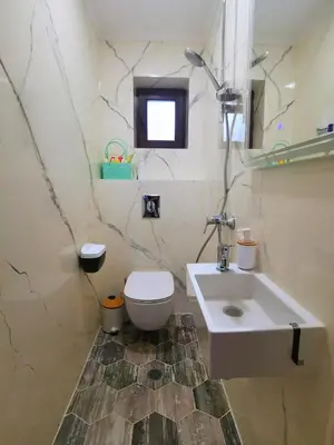 a bathroom with a white toilet and a sink at Timeless Sea in Tsarevo