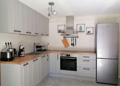 a kitchen with white cabinets and a white refrigerator at Timeless Sea in Tsarevo