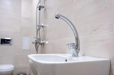 a white sink with a shower in a bathroom at Apartment Linda Cosy Getaway in Varna City