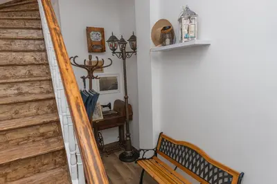 a stairway with a wooden bench next to a staircase at The Central House 2 in Burgas City