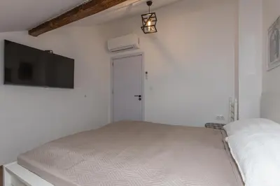 a bedroom with a bed and a flat screen tv at The Central House 3 in Burgas City