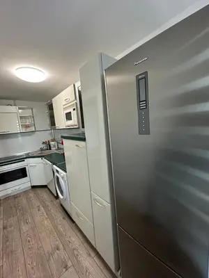 a kitchen with a refrigerator and a washer and dryer at Victoria in Varna City