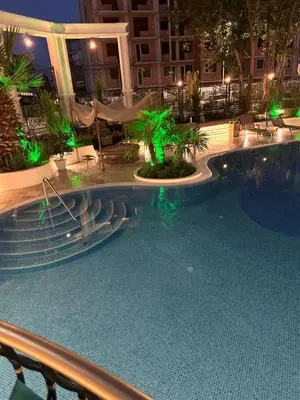 a swimming pool at night with green lights at Tranquilo Escapes in Sunny Beach