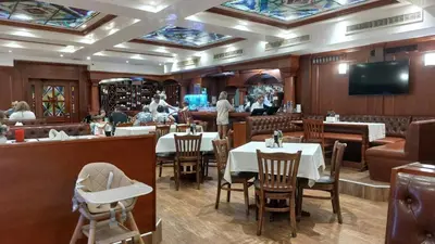 a dining room with tables and chairs in a restaurant at Helios Seaview Apartment in Sveti Vlas
