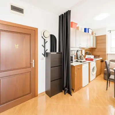 a kitchen with a door leading into a small kitchen at Helios Seaview Apartment in Sveti Vlas