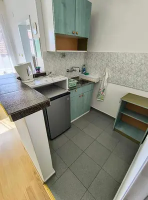 a kitchen with green cabinets and a sink at Вила Катажина - Villa Katarzyna in Sozopol