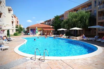 a large swimming pool with people in a hotel at Студио Sunny Day 6 Sunny beach in Sunny Beach