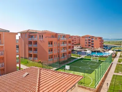an apartment with a tennis court and some buildings at Студио Sunny Day 6 Sunny beach in Sunny Beach