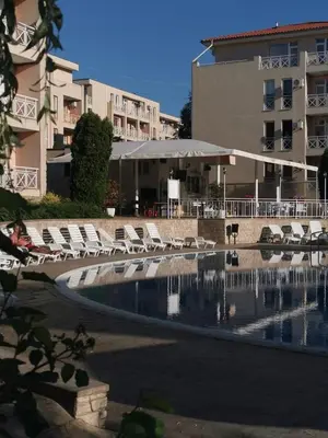 a swimming pool with lounge chairs next to a building at Студио Sunny Day 6 Sunny beach in Sunny Beach