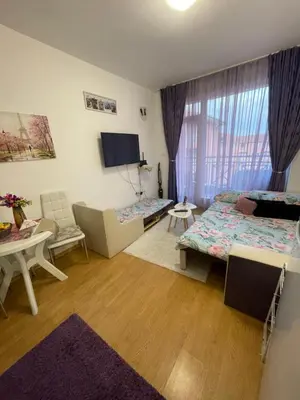 a living room with a bed and a couch at Студио Sunny Day 6 Sunny beach in Sunny Beach