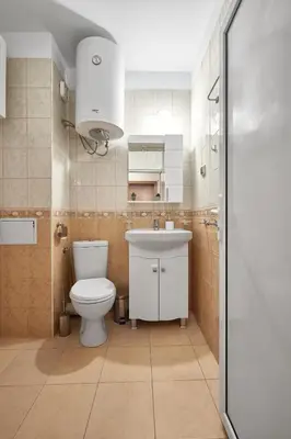 a bathroom with a toilet and a sink at Charming 1-Bedroom Apartment in Ravda by Flat Mаnаger in Nesebar